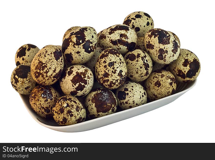 The photo shows quail eggs  close up on white background