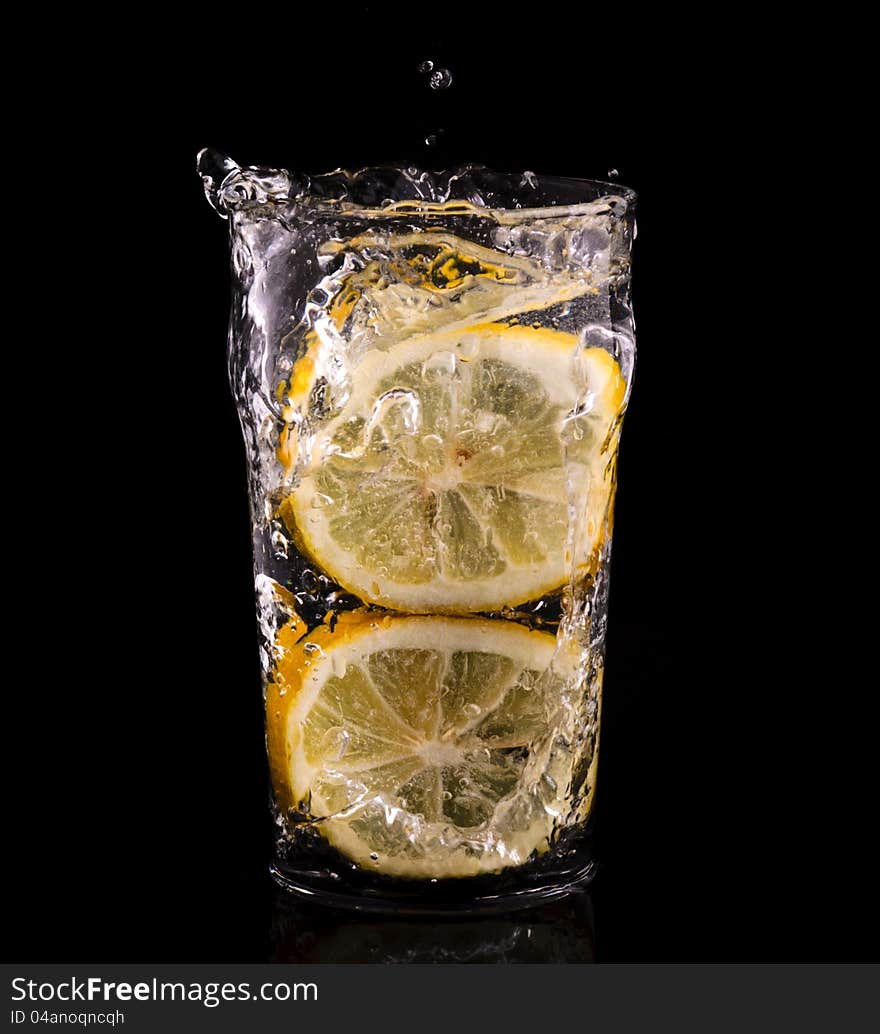 Sliced lemon splash into the water