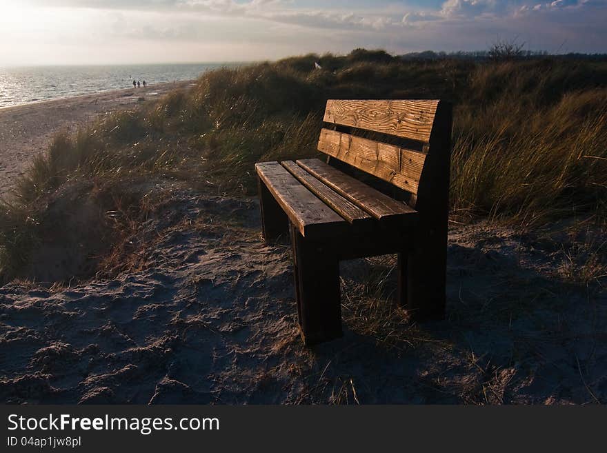 Bench on a dune with view on the Northern Sea in the background during sunset. The picture was taken on the Isle of FÃ¶hr in Northern Germany