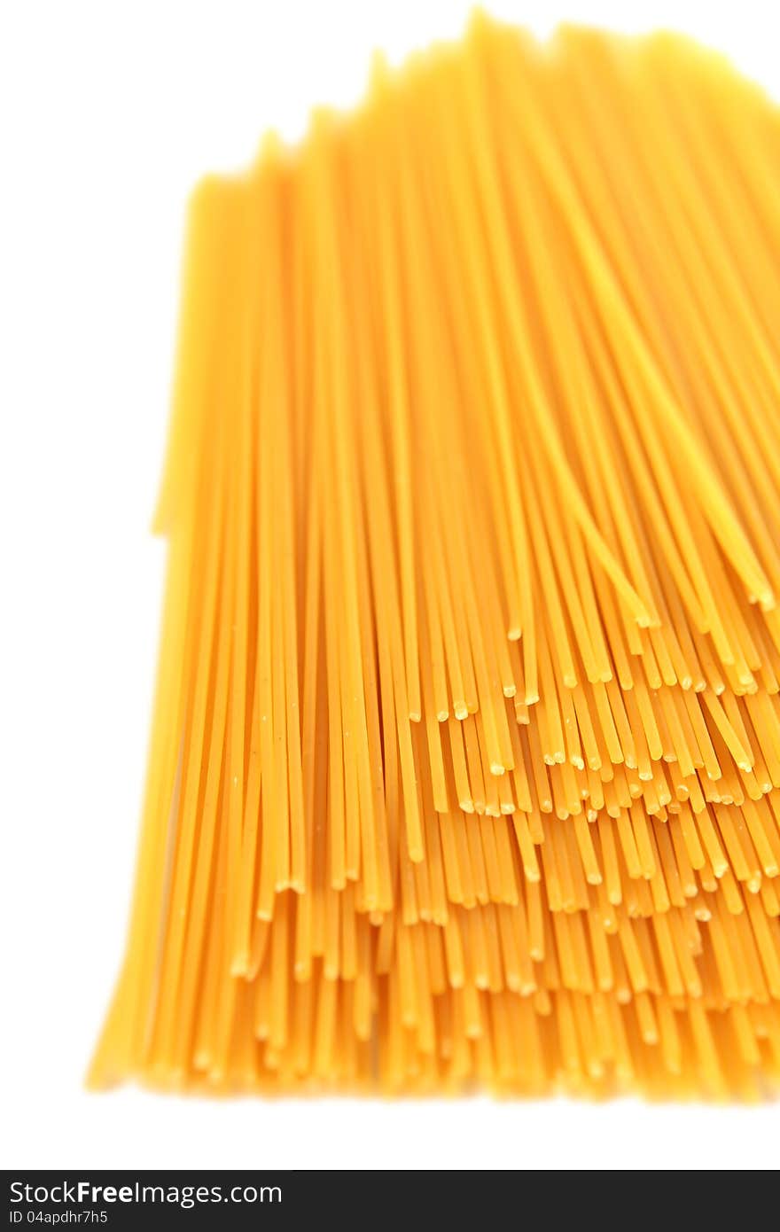 Spaghetti noodles stacked on a white background. Spaghetti noodles stacked on a white background