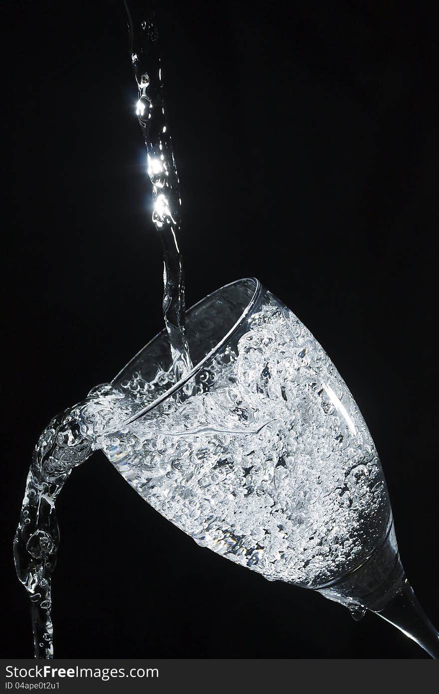 Sparkling water pouring in glass