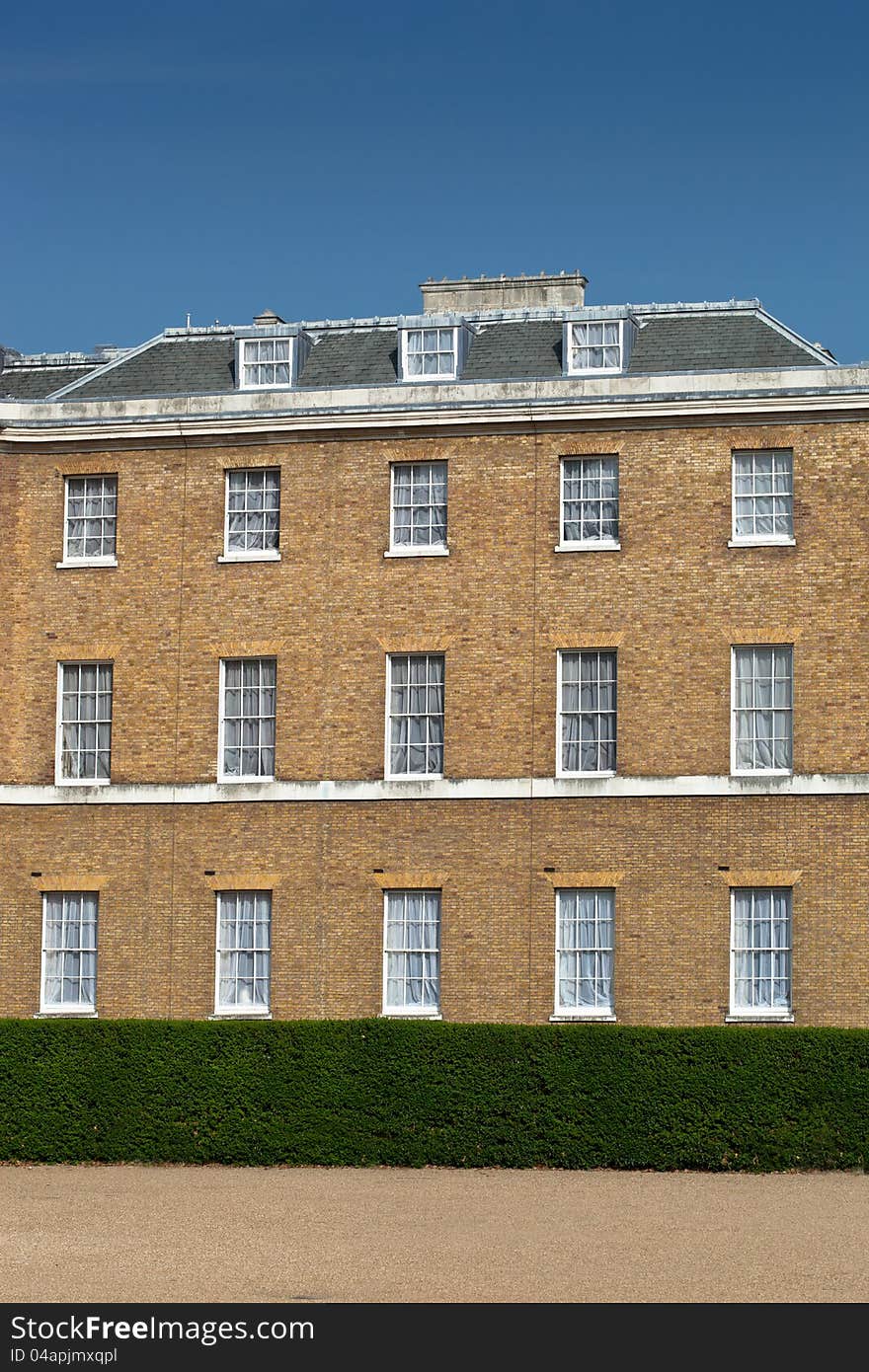 Various windows on an old yellow building