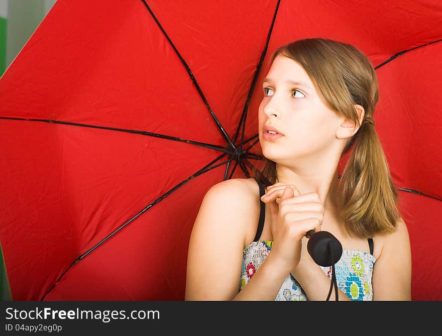 Teen with red umbrella is listening to the sound of falling drops od rain. Teen with red umbrella is listening to the sound of falling drops od rain.