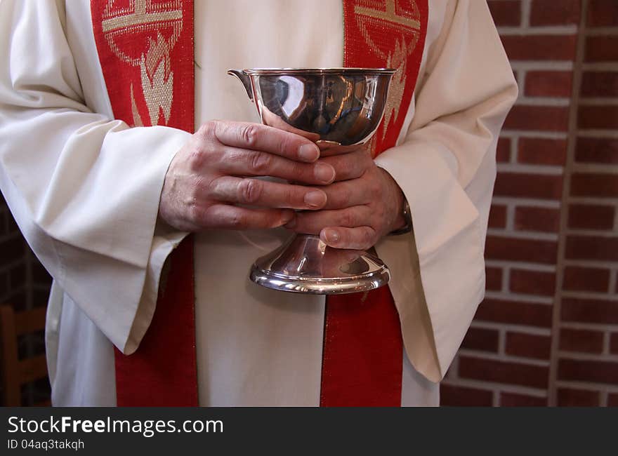 Hands holding a cup of vine for church communion. Hands holding a cup of vine for church communion