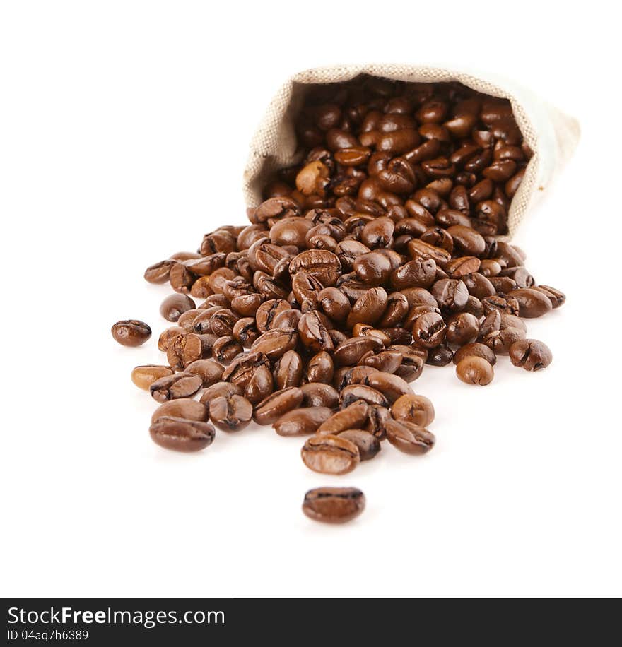 Grains of coffee pour out from a sack on a white background