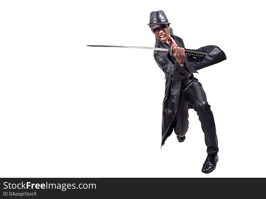 Black man wearing leather suit playing with sword. Black man wearing leather suit playing with sword