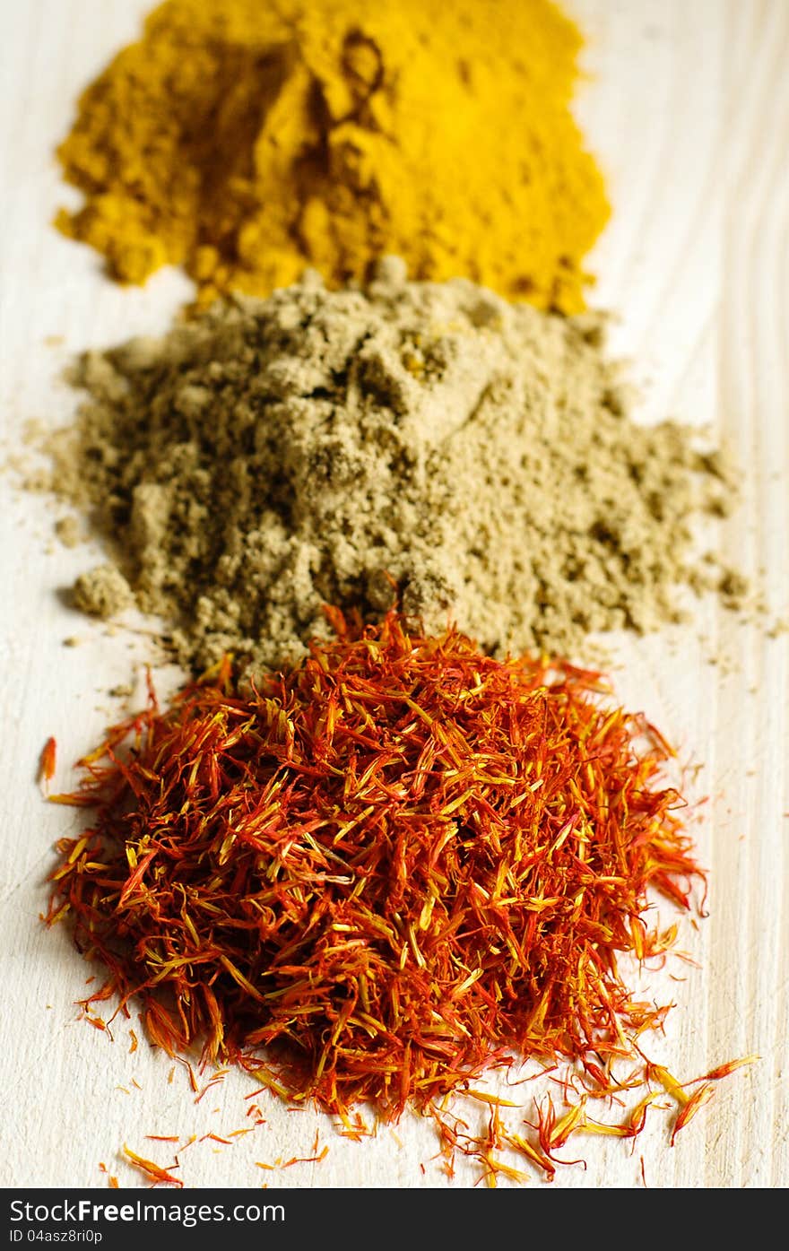 Saffron, zira and paprika on a wooden table. Saffron, zira and paprika on a wooden table