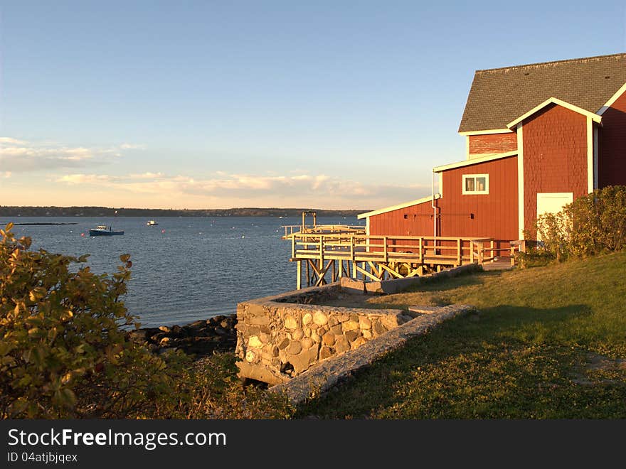 Red building at sunset along the coast of Maine. Red building at sunset along the coast of Maine.