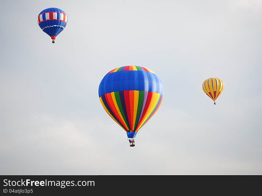 Three hot air balloons at the balloon festival.