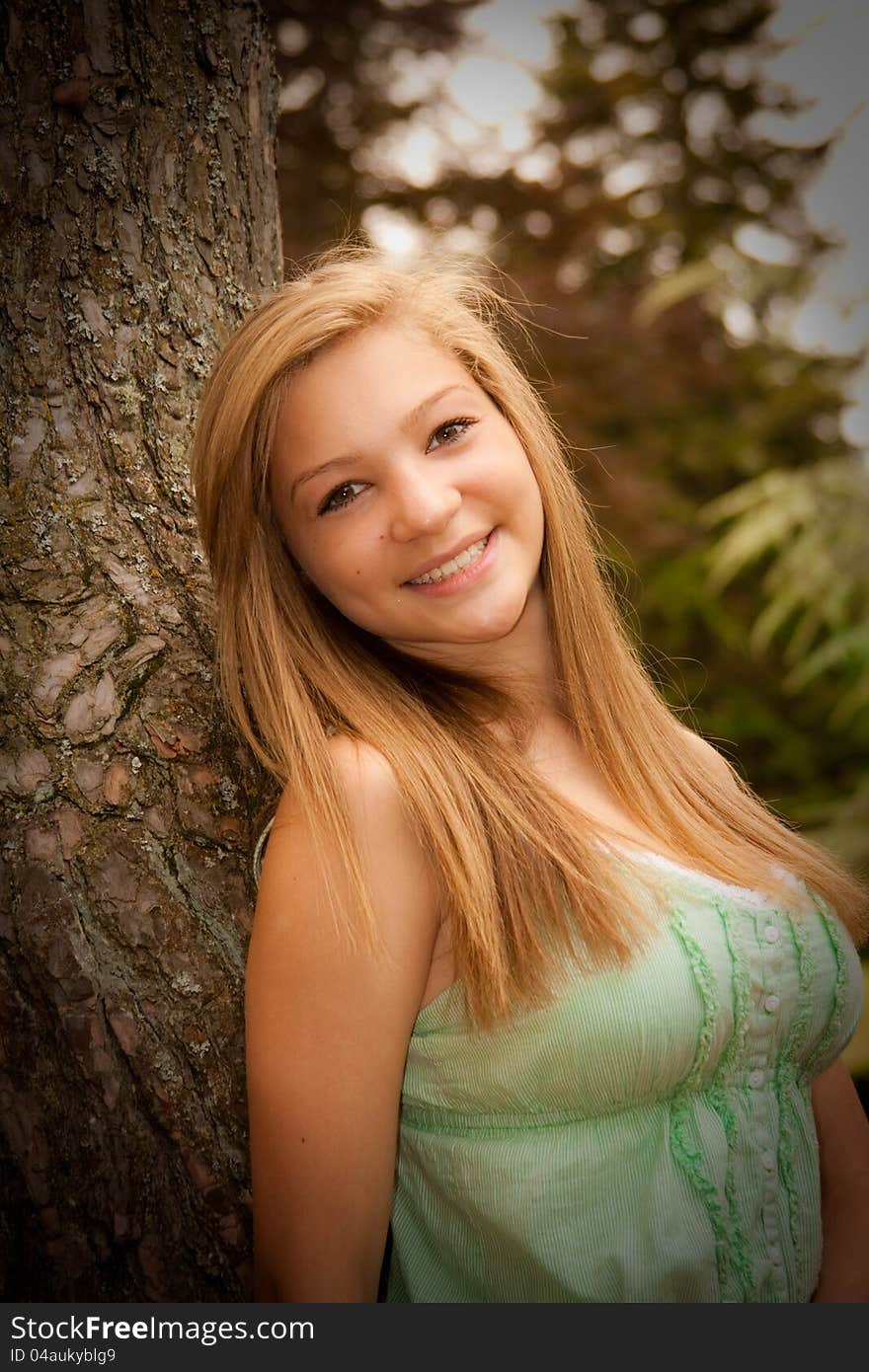 Teen girl at park with tree