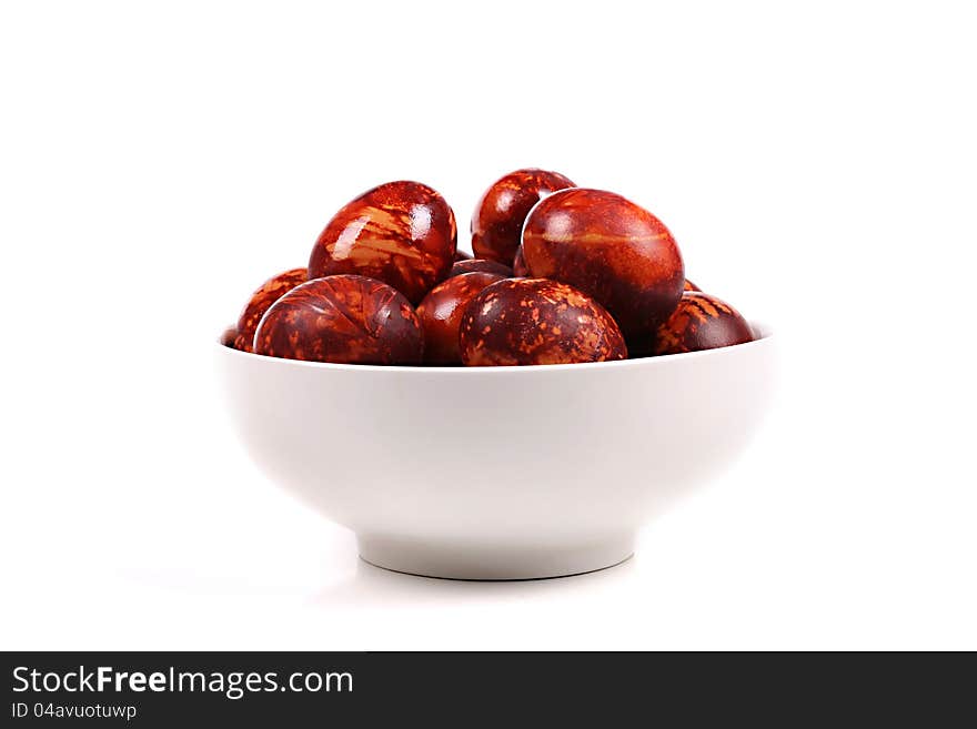 Bowl with colorful easter eggs isolated on white background