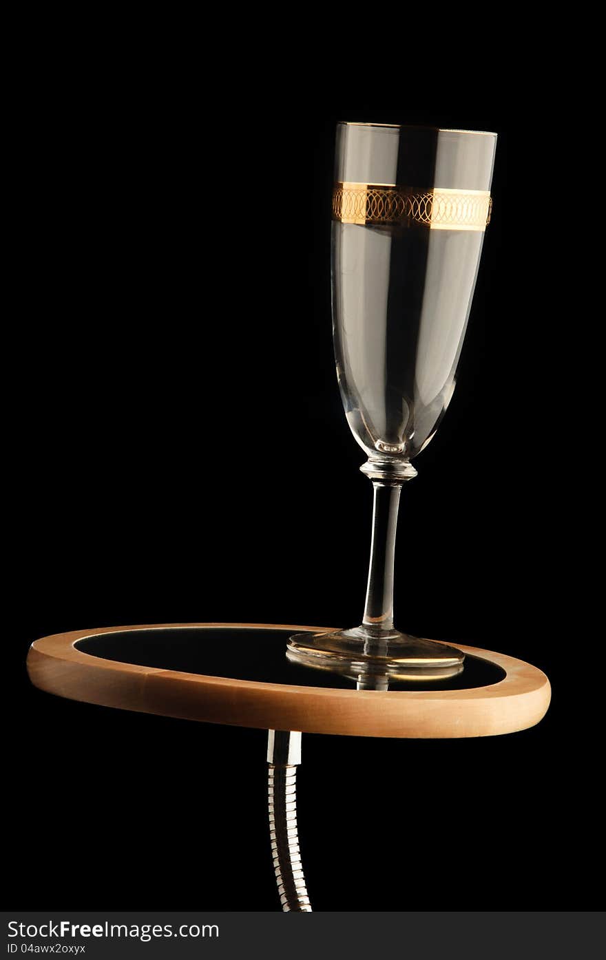 Empty champagne glass on mirror stand