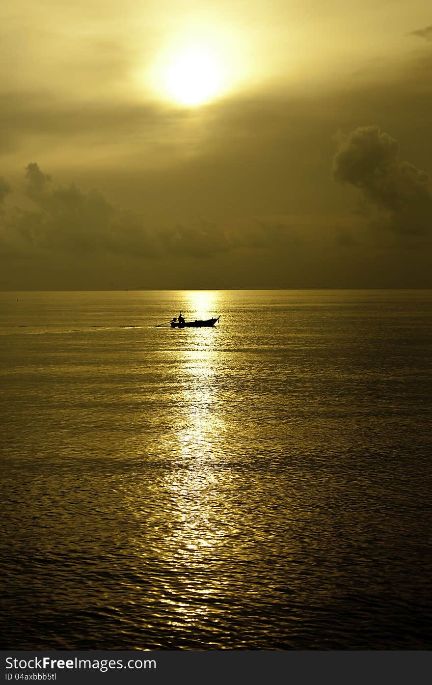 Tiny silhouette boat in the big ocean. Tiny silhouette boat in the big ocean