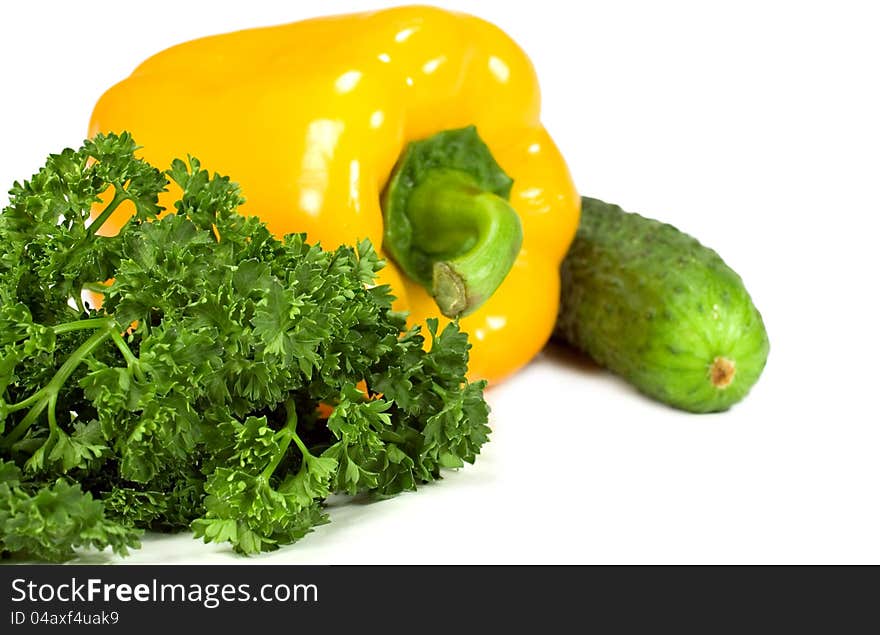 Pepper, cucumber and parsley on a white background. Pepper, cucumber and parsley on a white background