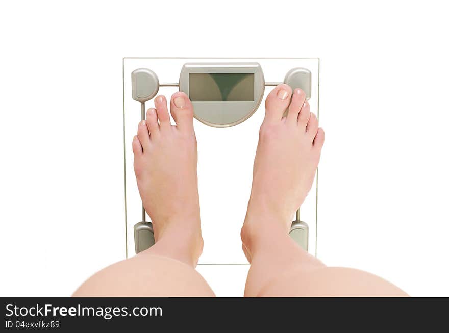 Female feet on scales. Isolated on white background.