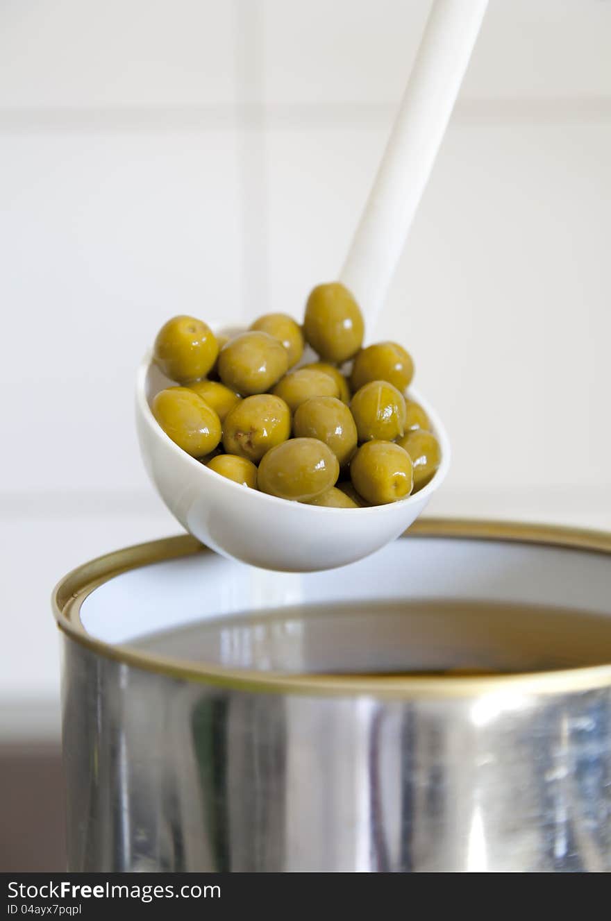 Picked green olives with a ladle to be served