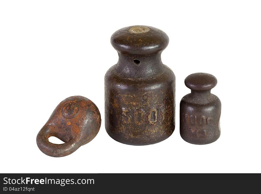 Three of the old weights for scales on a white background