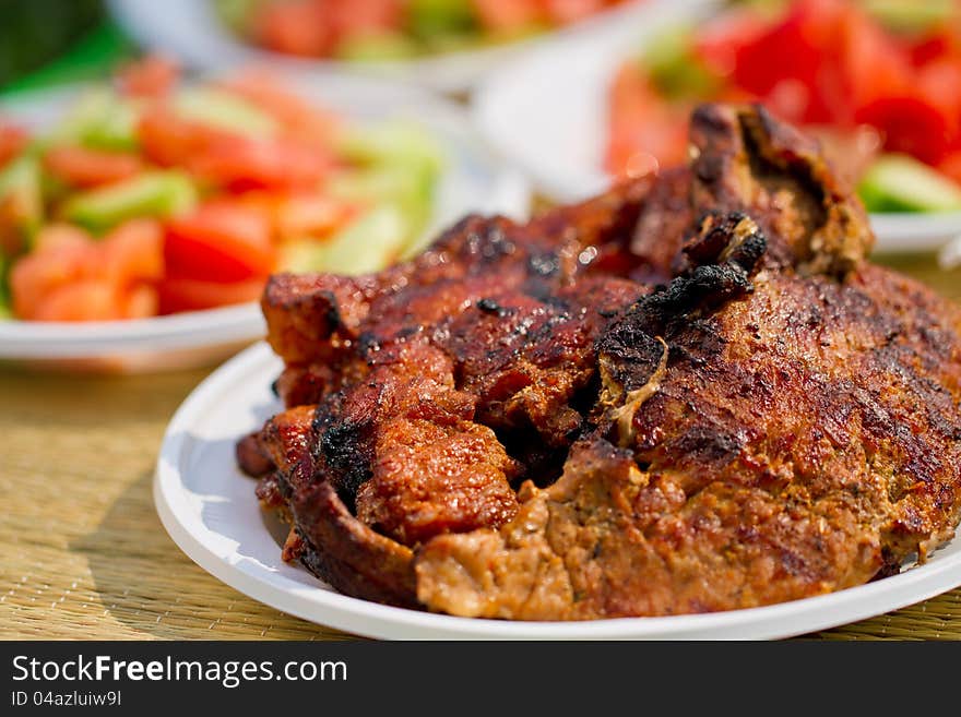 Fresh meat in white plate. Picnic picture proper for restaurant menu design.