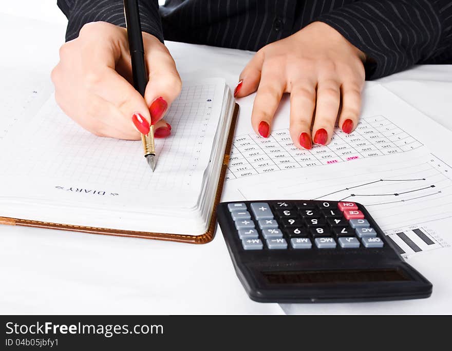 Business woman calculates and writes in the diary. Business woman calculates and writes in the diary