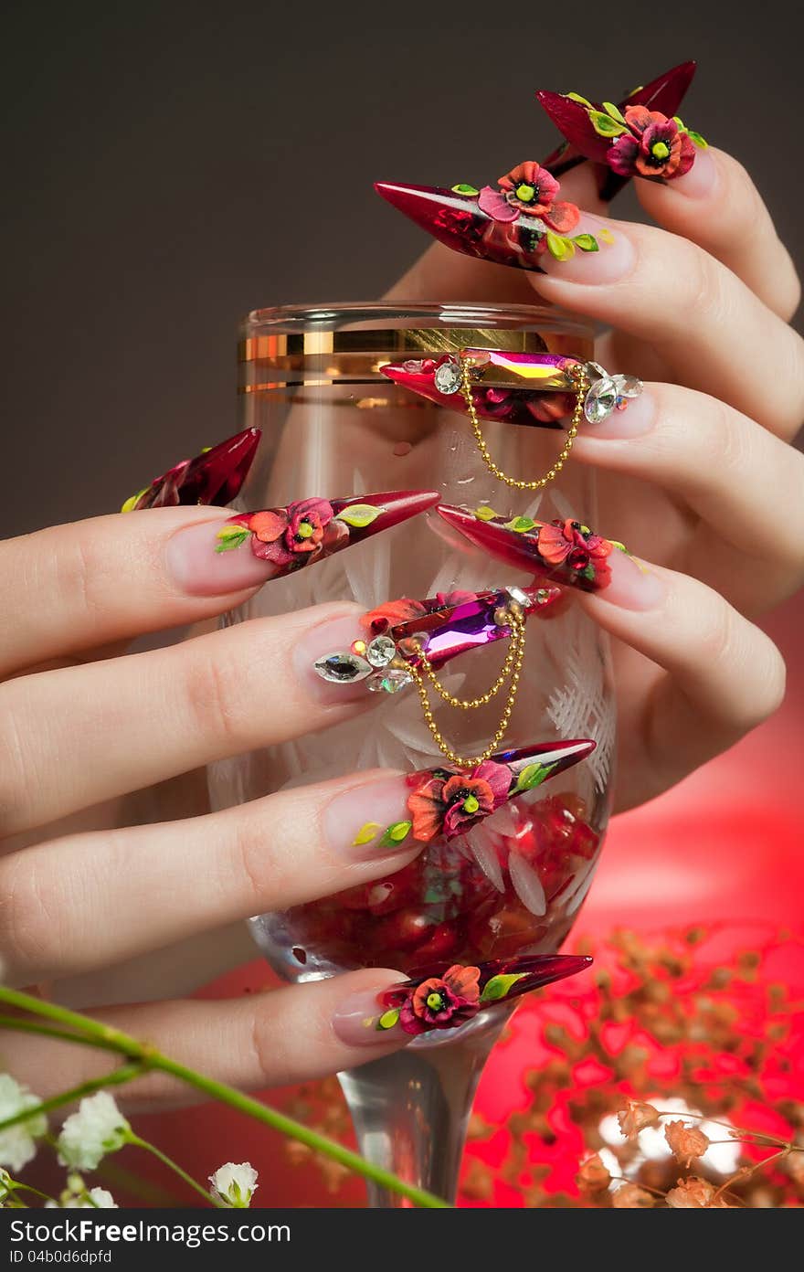 Manicure of beautiful hands with a glass