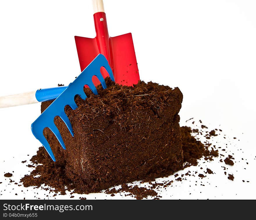 Image of plants earth with some garden tools isolated against a white background. Image of plants earth with some garden tools isolated against a white background