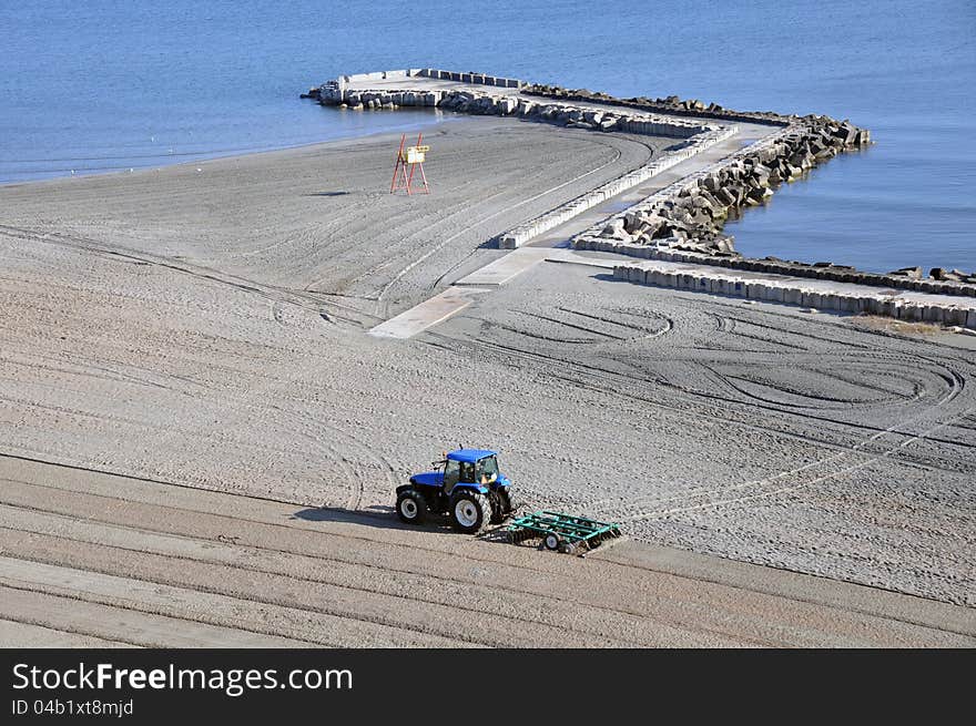 Tractor on the beach and Sunrise over the Black Sea at Mamaia resort near Constanta city in Romania. Tractor on the beach and Sunrise over the Black Sea at Mamaia resort near Constanta city in Romania