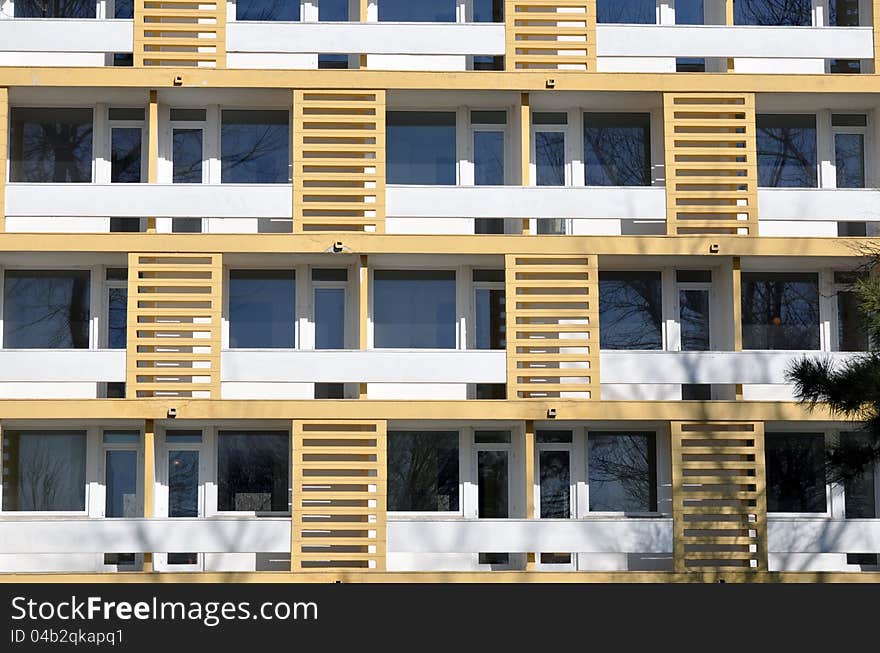 Yellow windows facade and on white building. Yellow windows facade and on white building