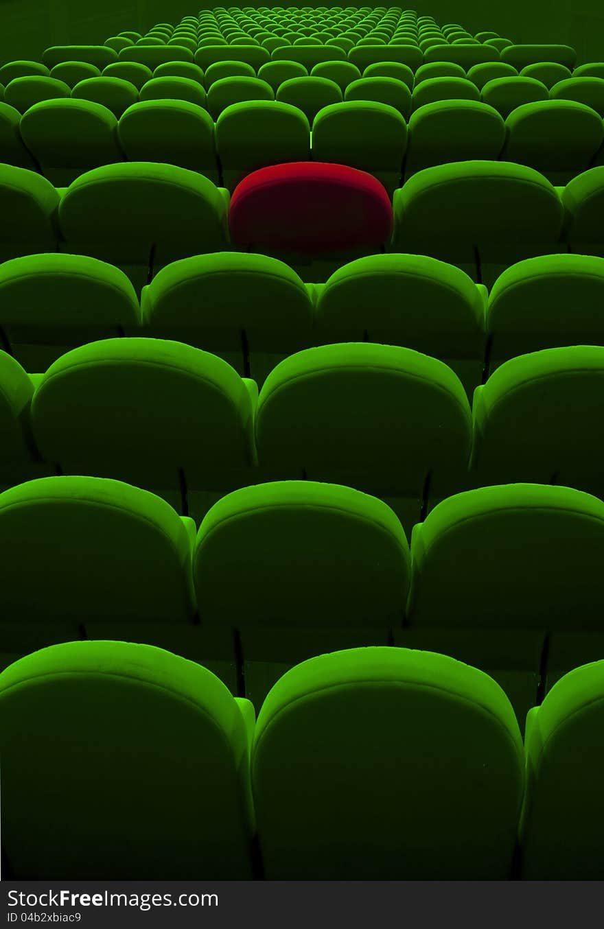 Green cinema or theater empty seats with red one. Green cinema or theater empty seats with red one