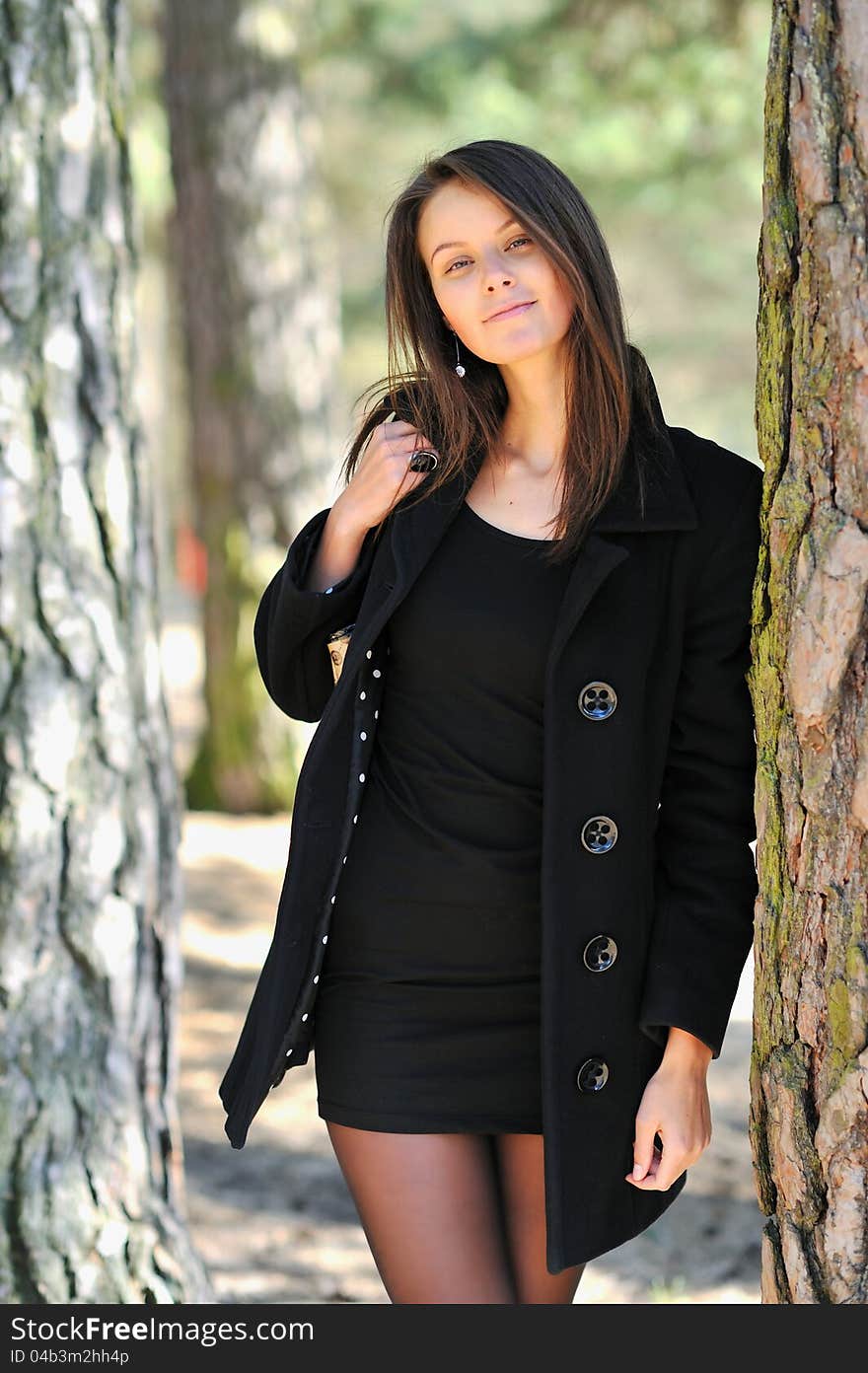 Pretty girl standing in a forest