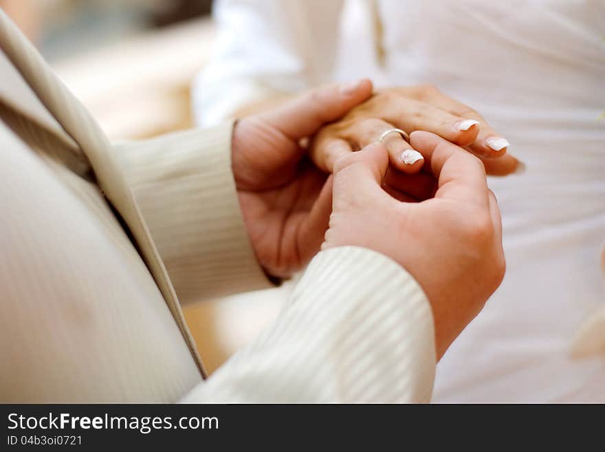 Putting a wedding ring on bride s finger