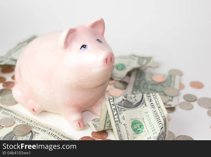 Pink piggy bank with coins and dollars. Pink piggy bank with coins and dollars