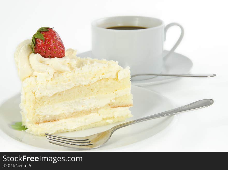 Delicious vanilla cake with strawberry decorate on top and a cup of coffee. Delicious vanilla cake with strawberry decorate on top and a cup of coffee