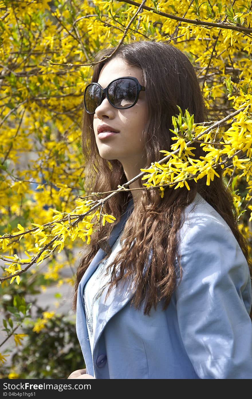 Beautiful young fashion girl dress up in spring clothes with sunglasses. Beautiful young fashion girl dress up in spring clothes with sunglasses