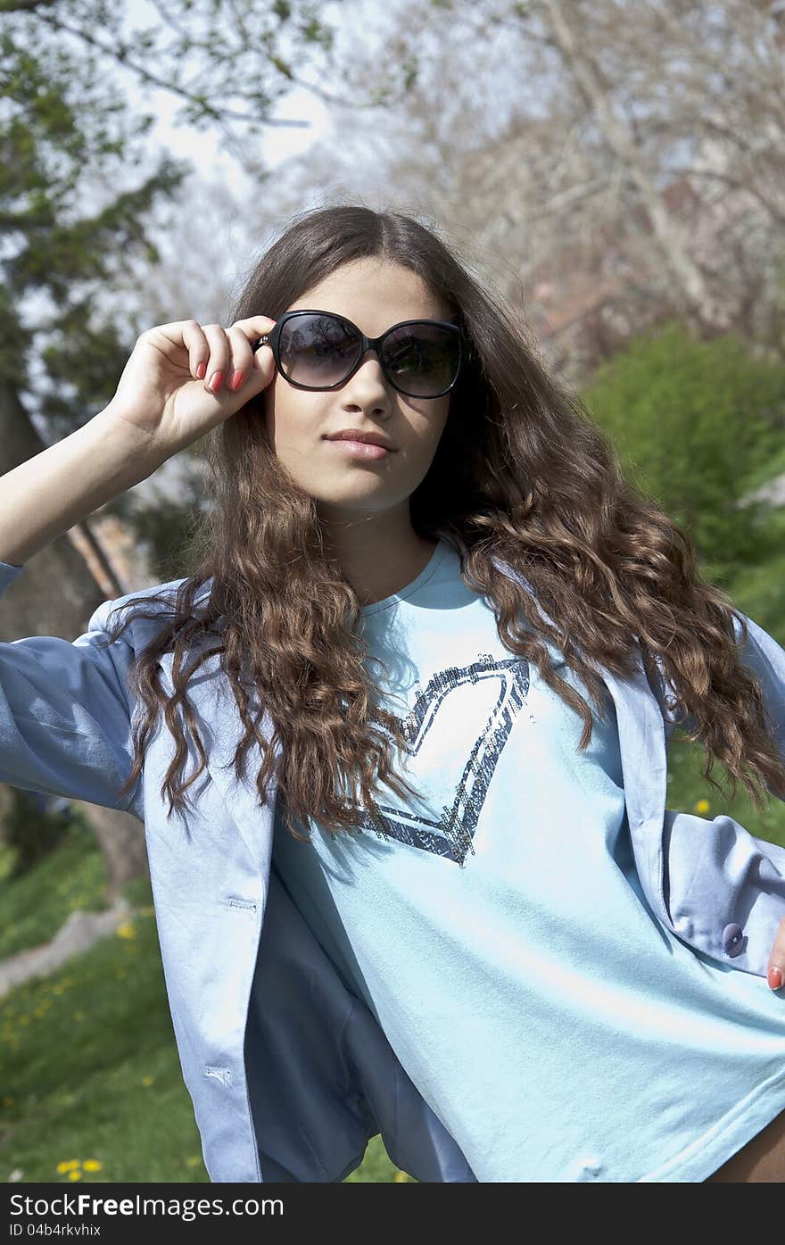 Beautiful young  girl dress up in spring clothes with sunglasses. Beautiful young  girl dress up in spring clothes with sunglasses