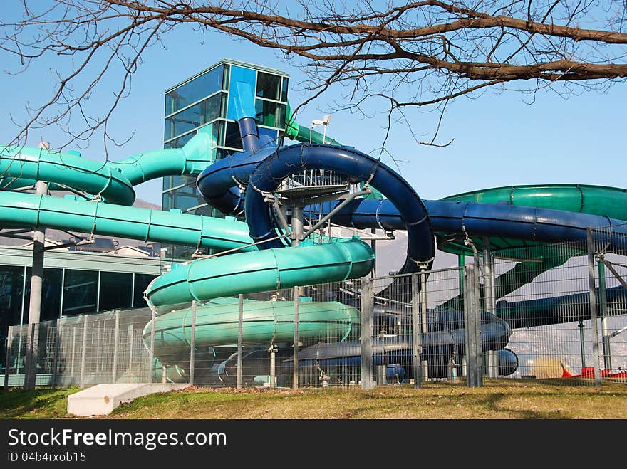 Several waterslide near swimming pool