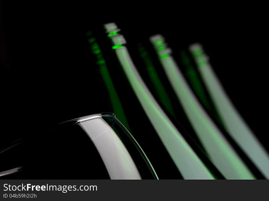 Bottles with glass on black background