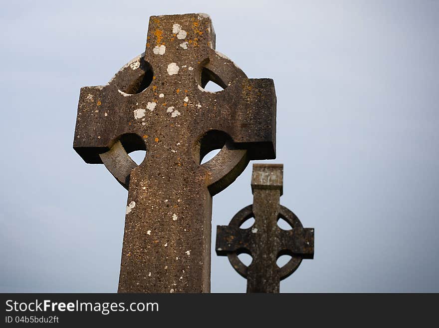 Two Old Celtic Stone crosses in the dusk