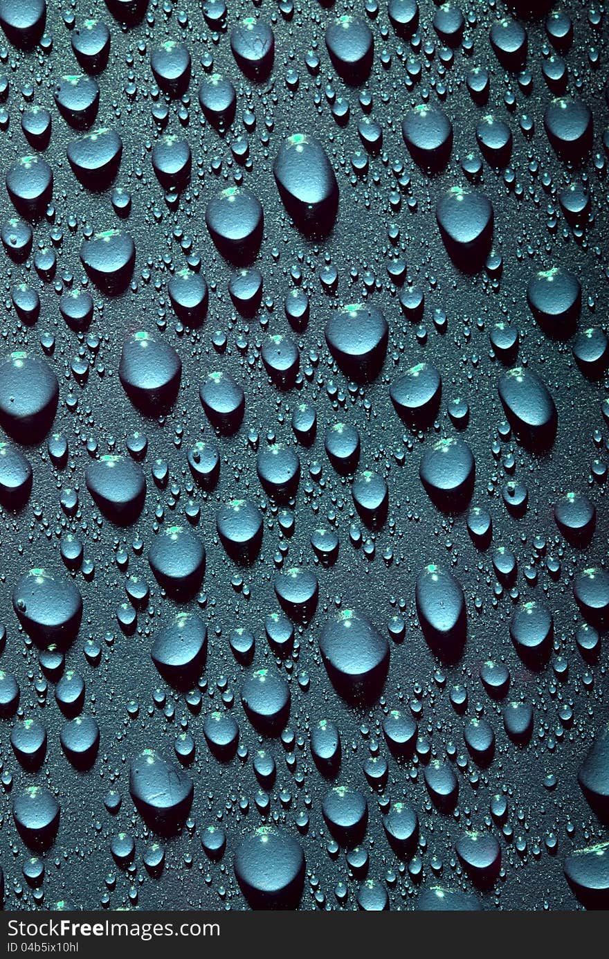 Crystal clear water drops over blue background