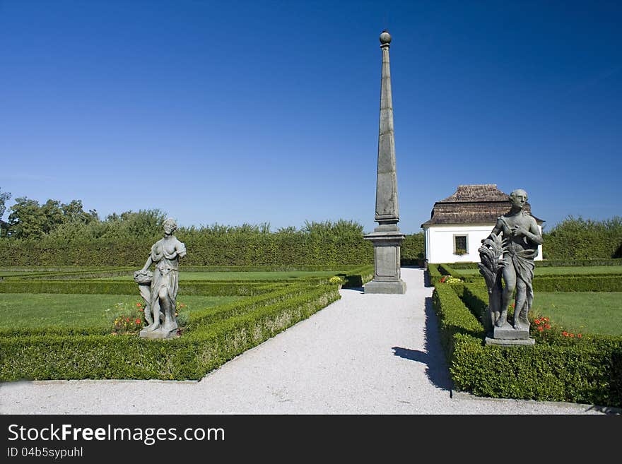 House garden with statues and obelisks, ornamental garden in the summer with a blue sky at chateau kuks. House garden with statues and obelisks, ornamental garden in the summer with a blue sky at chateau kuks