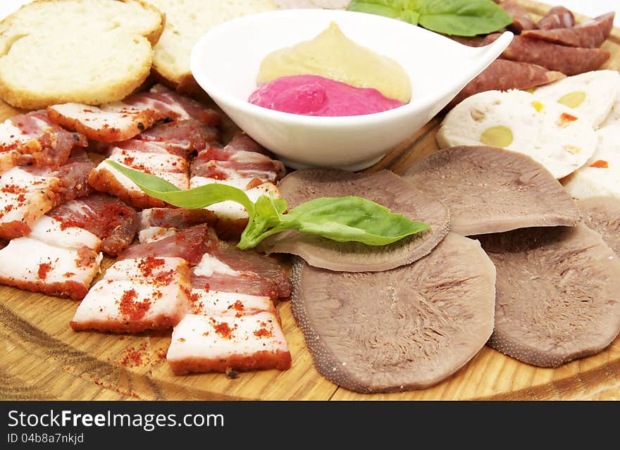 Bacon and sausage on a wooden platter in a restaurant