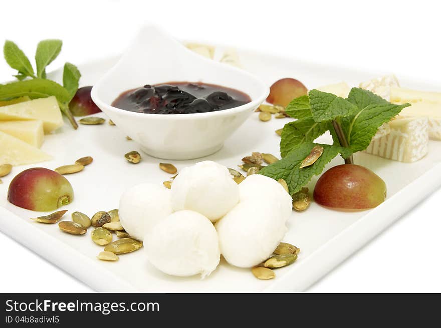 A plate of cheese and sauce on a white background