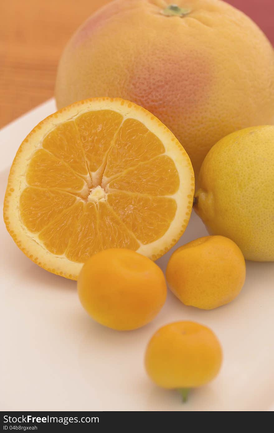 The Group Of Citrus Fruits On A White Plate