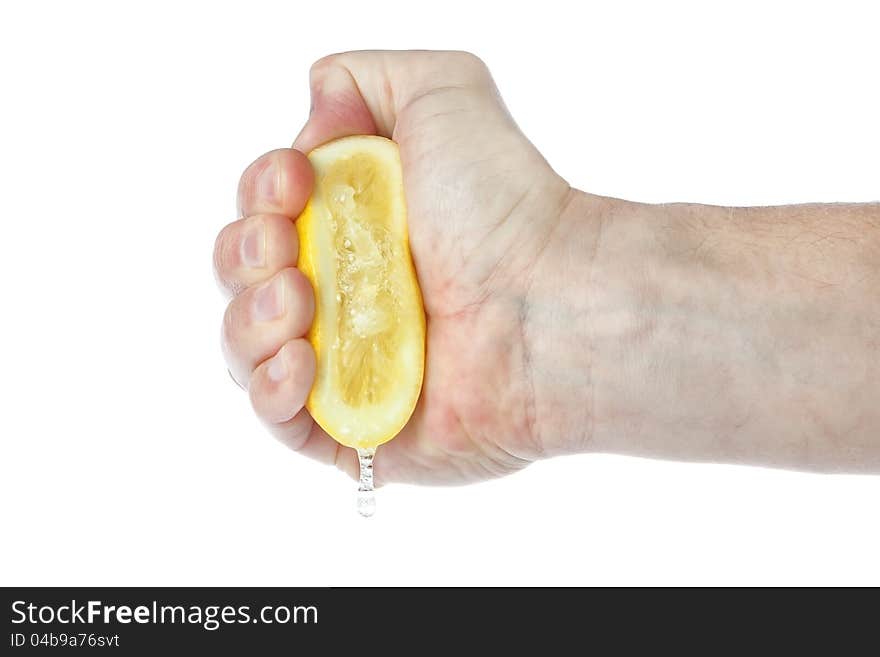 The hand squeezes a lemon. On a white background.