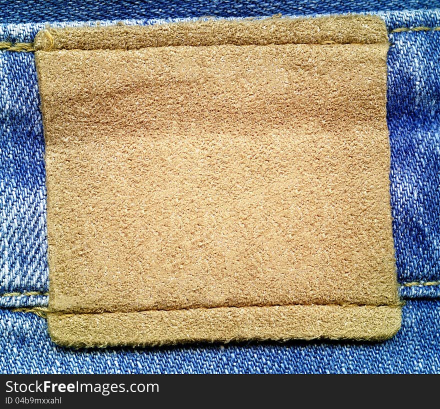 Brown leather jeans label sewed on jeans.