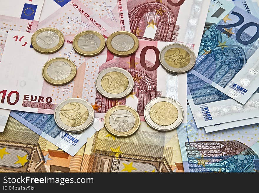 Background of different euro currency and coins closeup