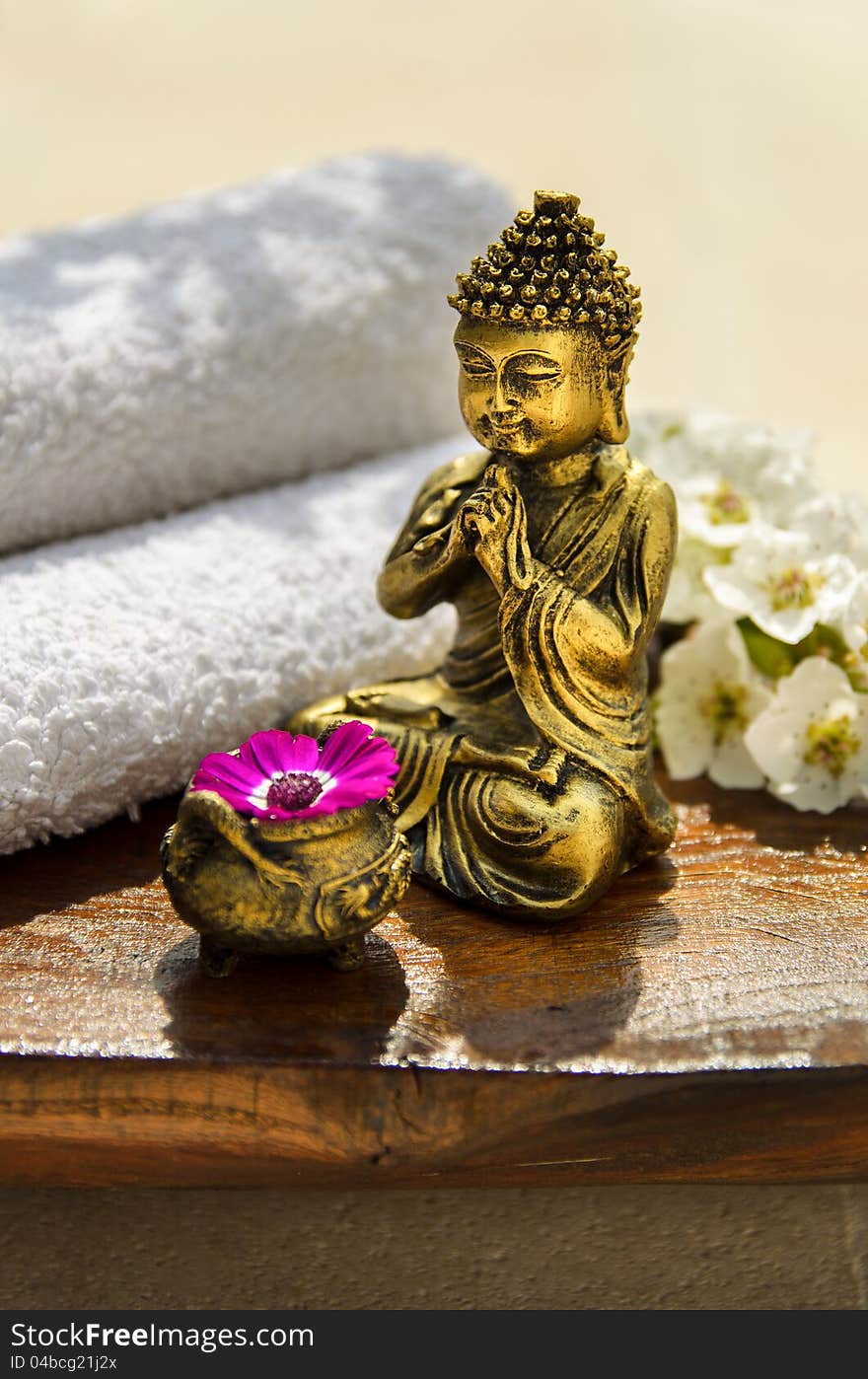 Spa concept with Buddha, towels, flowers and wood. Spa concept with Buddha, towels, flowers and wood.