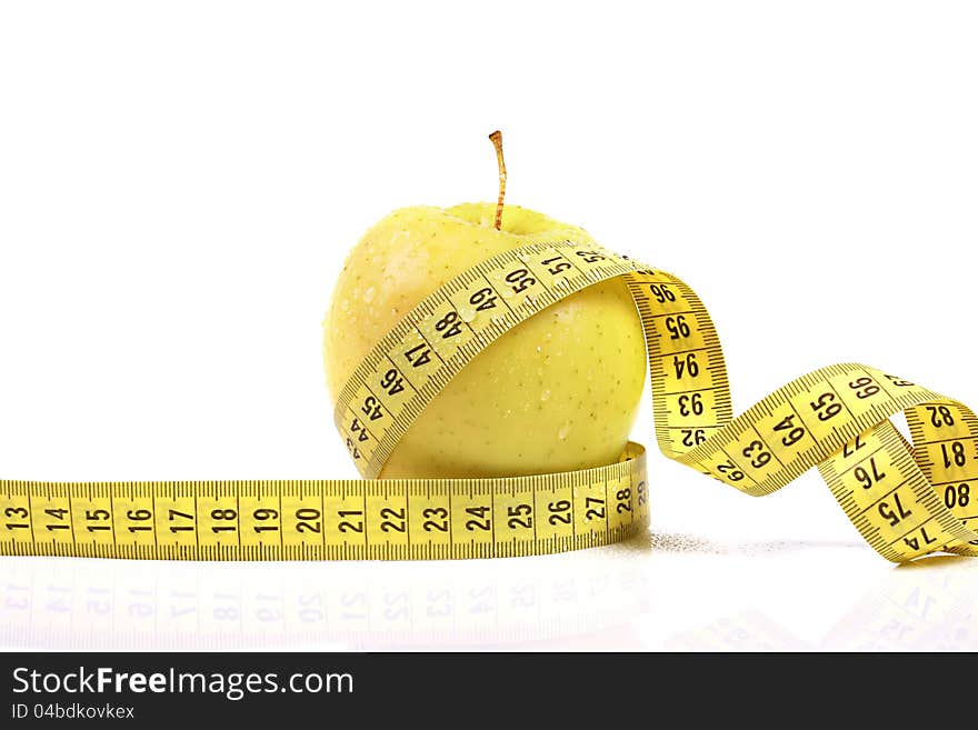 Diet concept. apple with measuring tape