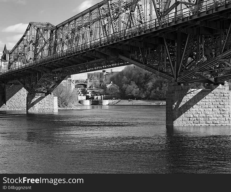 The outlet of the Rideau Canal locks at the Ottawa river in Ottawa, seen through the Alexandra bridge. High resolution scan from medium format film. The outlet of the Rideau Canal locks at the Ottawa river in Ottawa, seen through the Alexandra bridge. High resolution scan from medium format film.