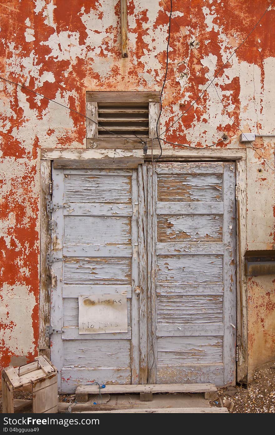 Grungy wall with weathered wooden doorway. Grungy wall with weathered wooden doorway