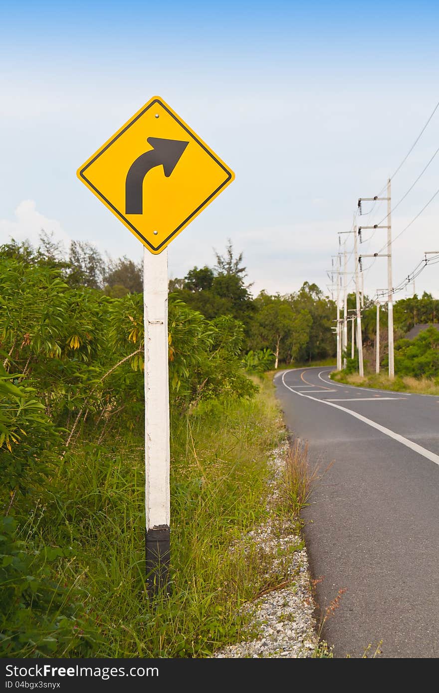 Traffic sign, right  way arrow with road and sky